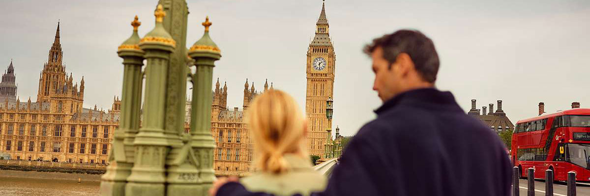 People looking at Big Ben over the Thames river, London.