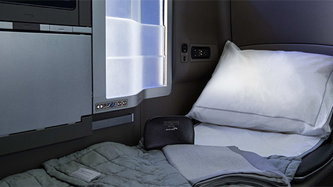 Club World seat with bed blanket and pillow.