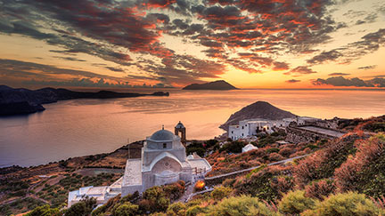 The sunset from the castle above the village of Plaka in Milos, Greece. Below the church of The Assumption of the Virgin Mary.