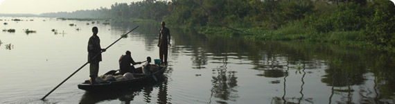 Men in fishing boat on river.