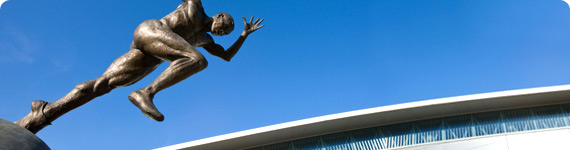 Bronze sculpture of running man.