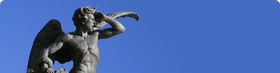 Statue in Madrid looking out at the blue sky.