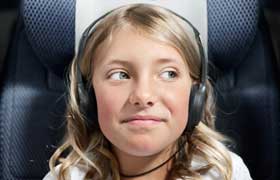 Child listening on headphones.