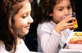 Children eating and drinking on board.