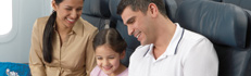 Parents and child on an aircraft.