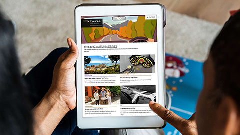 The digital Club Magazine on a tablet screen.