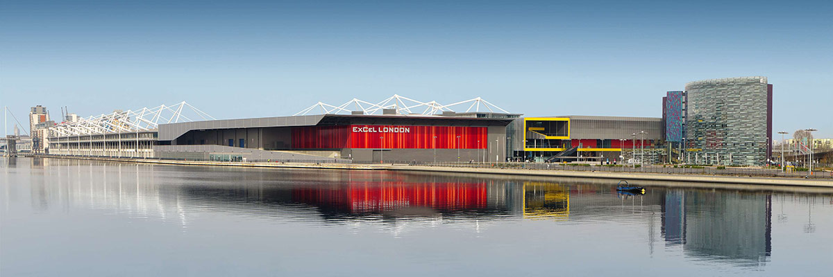 ExCeL London east entrance with reflection in water.