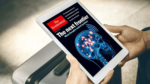 Digital edition of The Economist shown on a tablet resting on a piece of baggage.