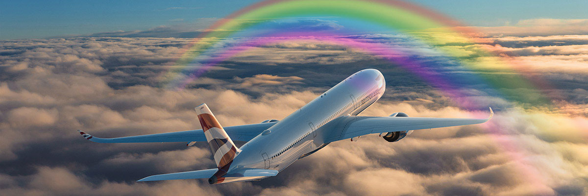A British Airways aircraft flying through a rainbow above the clouds.