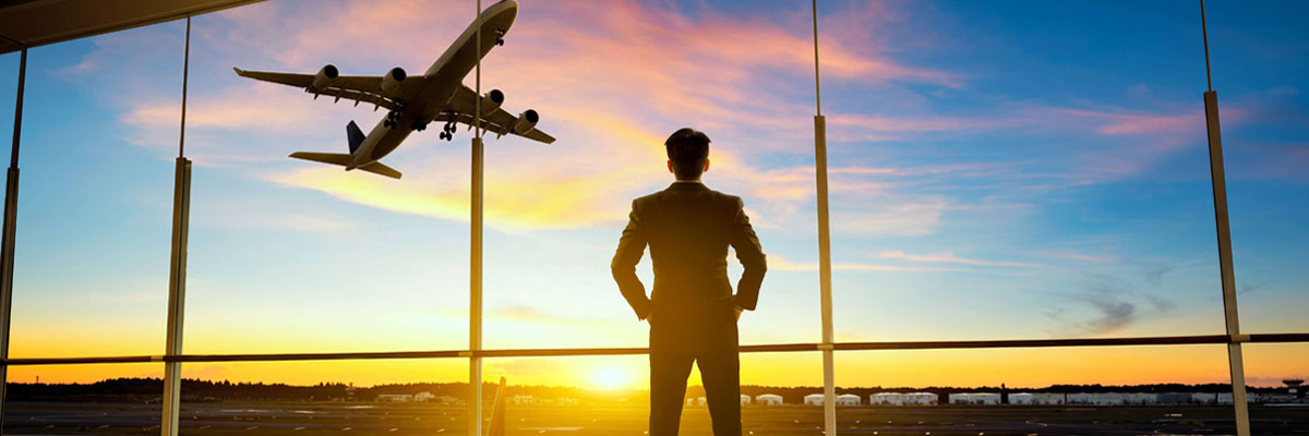 Man watching aeroplanes at airport with sunset. 
