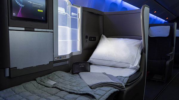 Club World seat with bed blanket and pillow.
