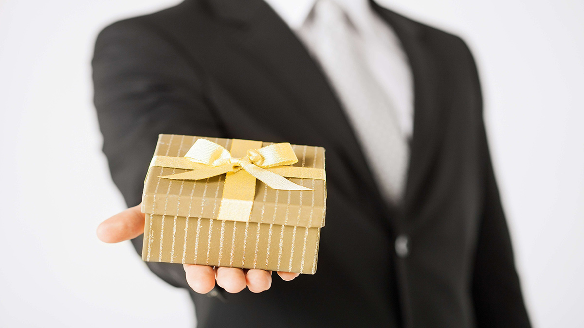 Close up of man hands holding gift box.