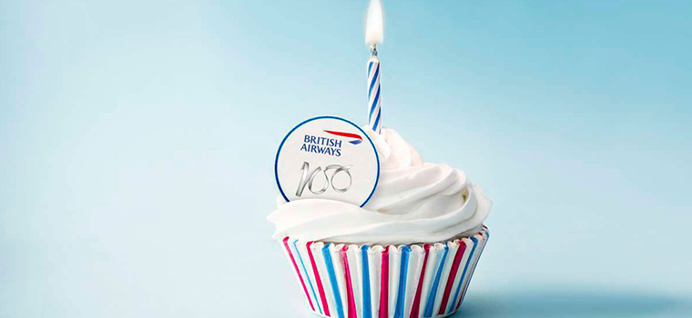 Cupcake with candle and British Airways logo.