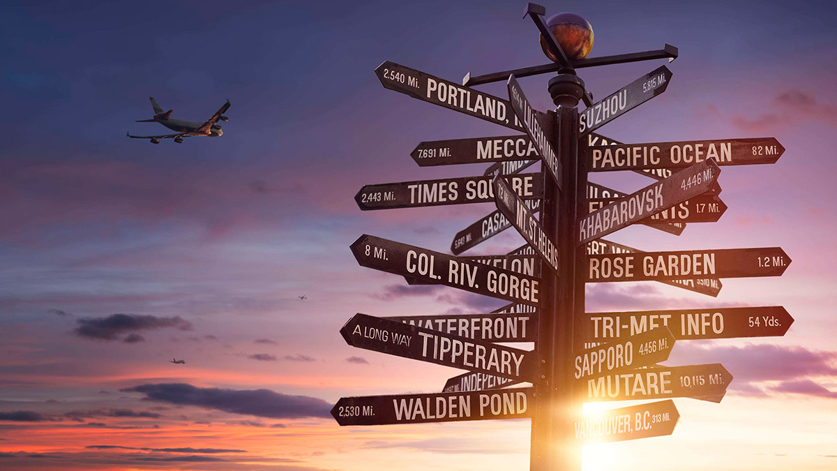 Travel the world! world landmarks signpost with sun and colorful cloudy sky in the background and free copy space for your text.