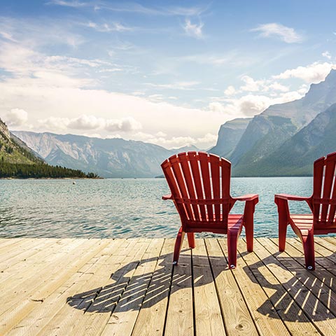 Jetty with chairs by Minnewanka Lake, Banff National Park, Alberta, Canada.