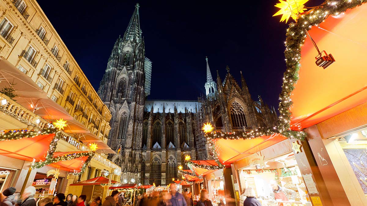 Christmas market in Cologne, with Cologne Cathedral visible in the background.