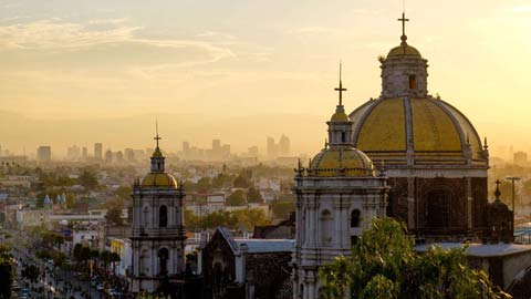scenic view at basilica of guadalupe with mexico city skyline at sunset, mexico.
