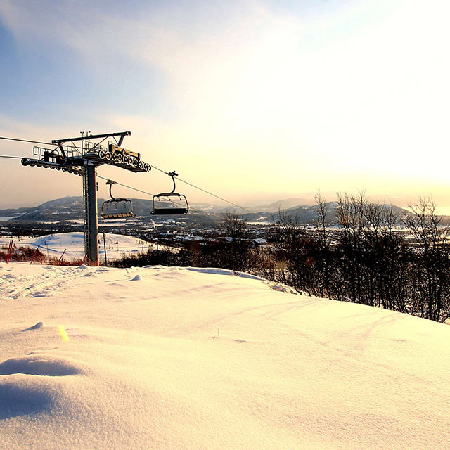 Ski resort chair lift aloft a Norwegian mountain slope in Beitostolen.