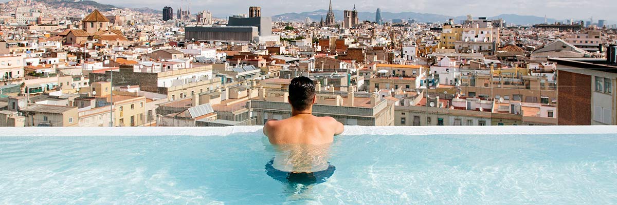 Homme surplombant Barcelone dans une piscine.