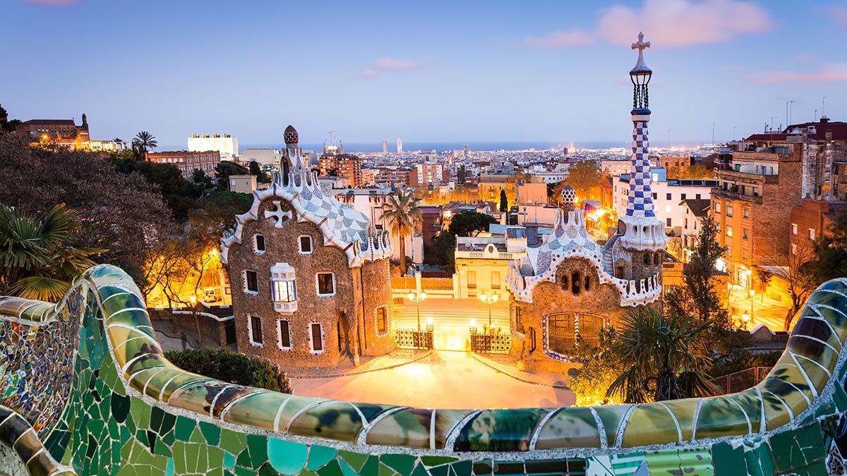 Parc Guell at sunset, view of the city with seaside in background. Barcelona, Spain