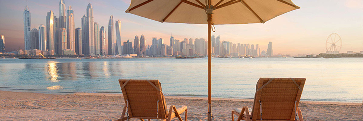 Lounge Chairs And Parasol Against Sea At Beach, Dubai.
