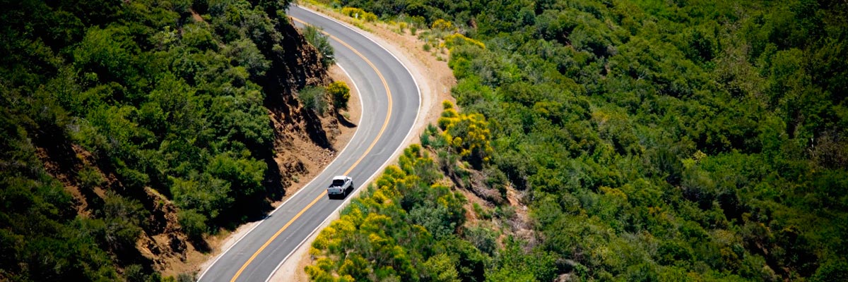 Truck driving on curvy road in mountains, elevated view. Los Padres National Forest, Ojai, California, USA.