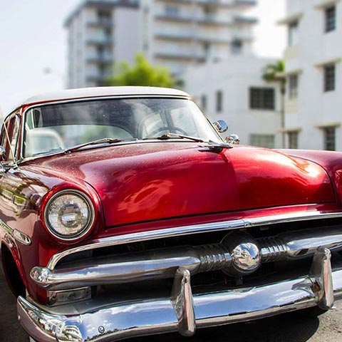 A shiny red vintage car from the 50s, Miami Beach.