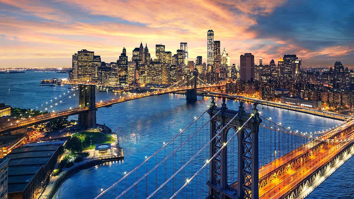New York City - beautiful sunset over Manhattan with Manhattan and Brooklyn bridge.