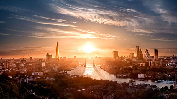 Tower Bridge and London skyline at sunset.