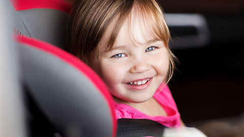Little girl in a safety seat.