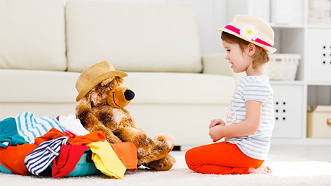 Little girl playing with her soft toy.