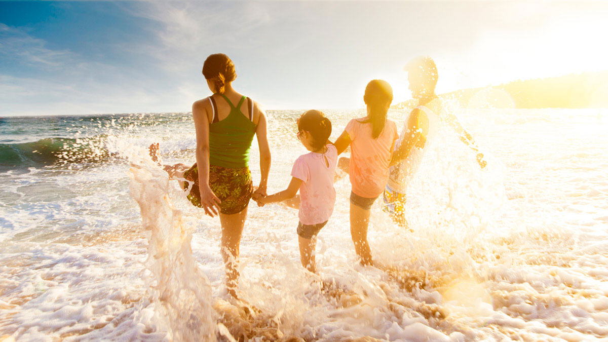 A family splashing in the waves on a family
