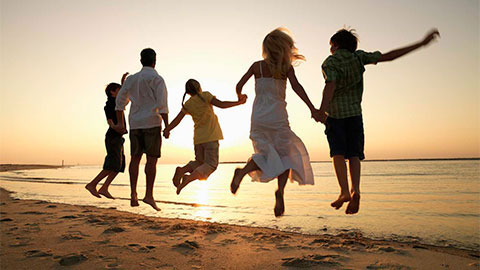 Family jumping on a beach.