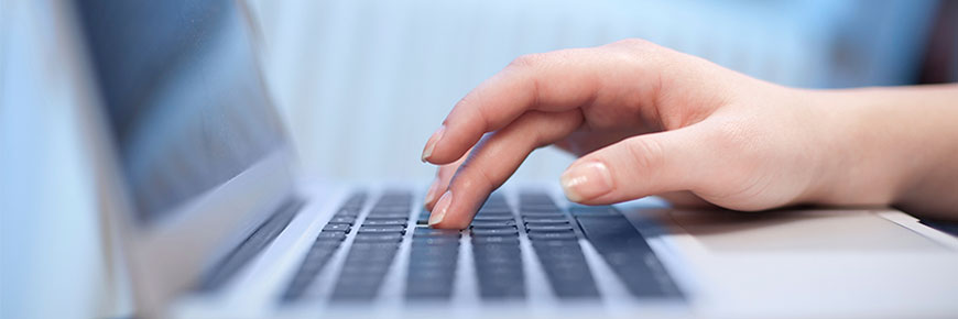 Person using a laptop keyboard.