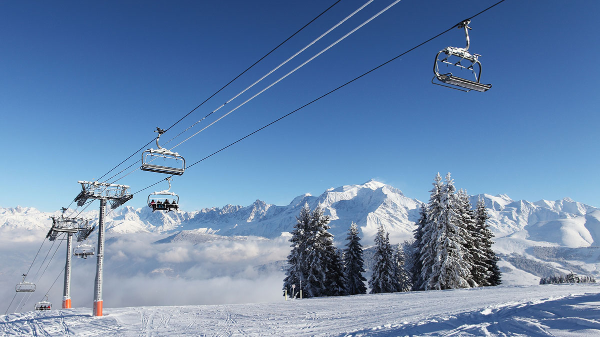 Cable cars over snowy mountains in Megeve, France © Martial Colomb / Getty