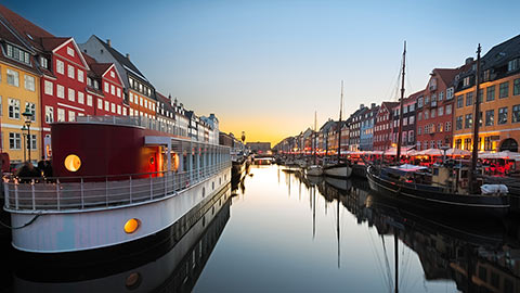 Ships in Nyhaven at sunset, Copenhagen, Denmark.