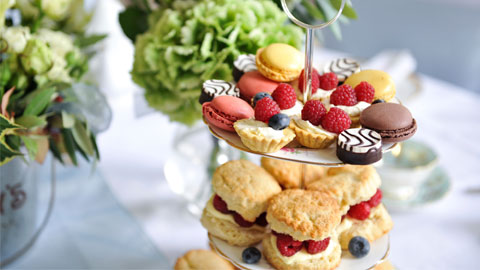 An assortment of afternoon tea cakes on a vintage cake stand.